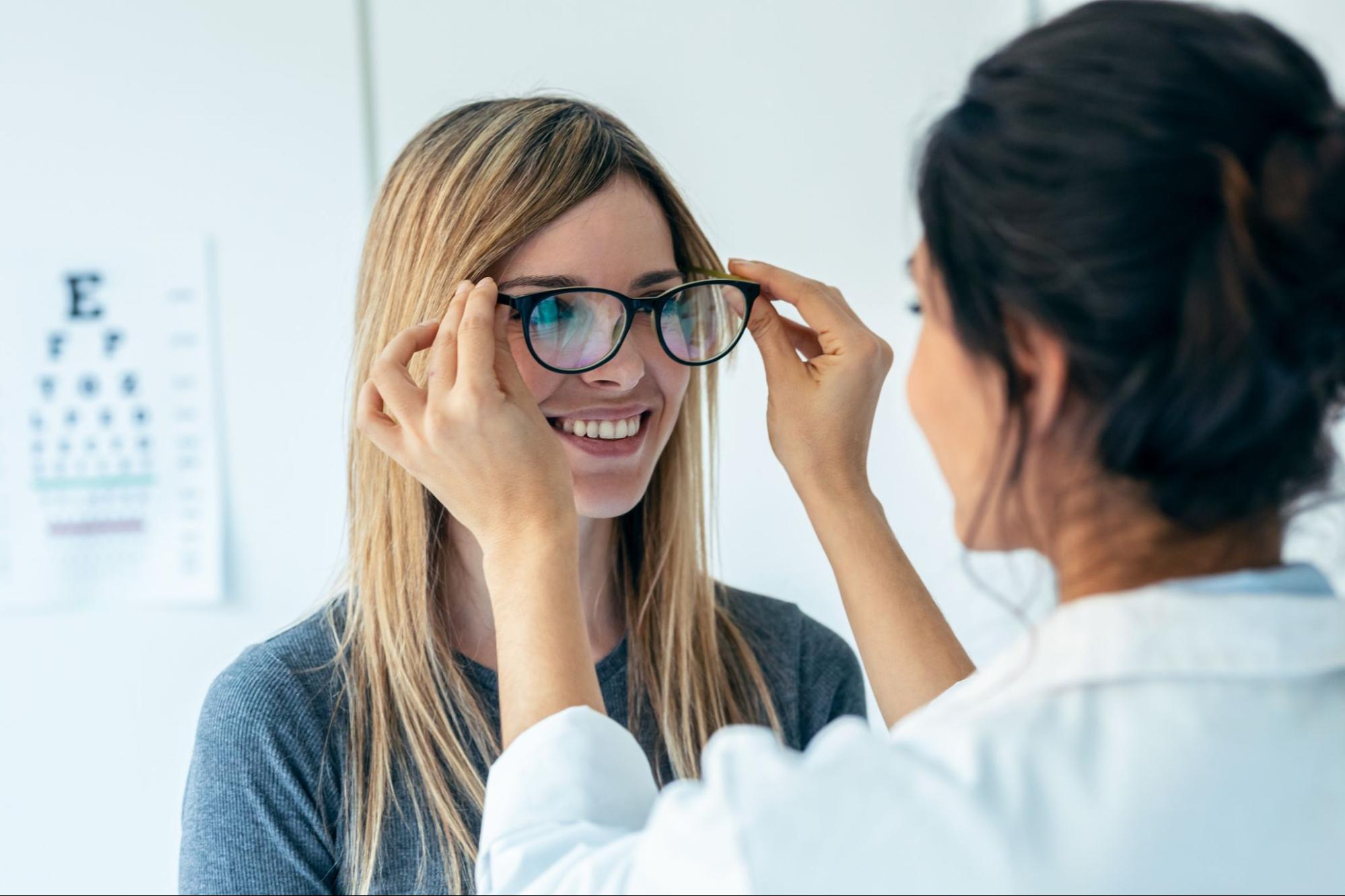 doctor giving patient glasses